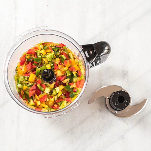 food processor with chopped peppers inside