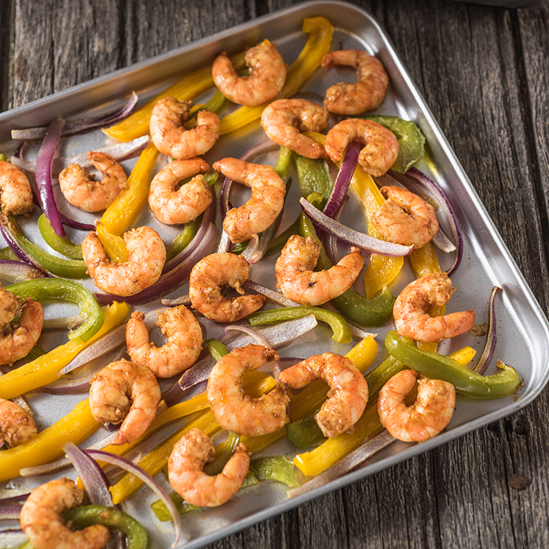 shrimp and peppers on a sheet pan